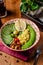 Useful Italian vegan food. Vegetarian bowl for breakfast of porridge couscous, avocado, cucumber, Brussels sprouts and vegetable