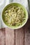 Useful raw zucchini pasta in a bowl close up. vertical top view