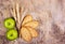 Useful snack. Grain organic cookies and juicy green apples. Wheat ears on an old wooden background.