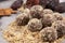 Useful sweets or fitness snack without sugar. Homemade energy balls. Mixture of nuts and dried fruits lies on a plate, close-up