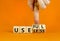 Useful or useless symbol. Concept words Useful or Useless on wooden cubes. Businessman hand. Beautiful orange table orange