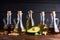 Useful vegetable oils in glass bottles. Avocado oil, chickpea oil, linseed oil, peanut oil, almond oil. Dark background