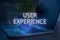 User experience inscription against laptop and code background. Technology concept