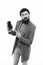 User outraged. Man brutal bully appearance hold smartphone isolated white. Bearded brutal guy pointing at smartphone