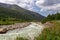 Ushguli- Patara Enguri River flowing down the valley in the Greater Caucasus Mountain Range in Georgia. Flowers