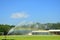 Using an automatic water sprayer the field to keep the grass moist and beautiful. in the water spray and the beautiful blue sky