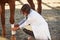 Using bandage to heal the leg. Female vet examining horse outdoors at the farm at daytime