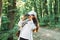 Using the binoculars. Girl is in the forest at summer day time discovering new places