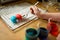 Using food coloring to dye Easter eggs at home. Painting colorful eggs for Easter hunt. Getting ready for Easter celebration