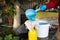 Using gauze in the garden, a woman strains fertilizer and pours it into a spray bottle. The gardener prepares a solution
