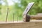 Using hammer and nails and curved nail on wood and bokeh background