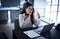 Using her connections to ensure the job gets done. a young businesswoman using a cellphone and laptop while working in