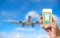 Using mobile smart phone buy ticket Airport Flight. Airplane background bulr