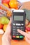 Using payment terminal, fruits and vegetables, cashless paying for shopping, enter personal identification number