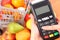 Using payment terminal, fruits and vegetables, cashless paying for shopping, enter personal identification number