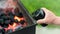 Using portable electric barbeque air blower for grilling at outdoor camp.