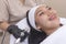 Using an RF electromagnetic device for radiofrequency skin tightening or contouring treatment. At a facial care, dermatologist