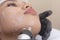 Using an RF electromagnetic device for radiofrequency skin tightening or double chin reduction. At a facial care, dermatologist or