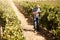 Using technology to find more sustainable form management methods. a farmer using a digital tablet working in a vineyard
