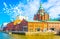 Uspenski Cathedral rising above red brick buildings of former merchant port now transformed into public place in