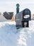 USPS metal mailbox buried in snow drift I voted sticker for vote by mail