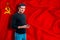Ussr flag on the background of the texture. The young man smiles and holds a smartphone in his hand. The concept of design