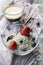 Usual breakfast: glass bowl with flakes and berries, cup of black coffee