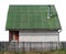 Usual no name  rural barn shed  with green roof  for storage of firewood and agricultural tools isolated