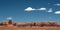 Utah desert buttes with a few clouds in a blue sky