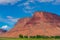 Utah landscape with red Butte and farm