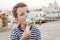 Ð¡ute seven-year-old boy in a striped t-shirt sits on the waterfront in Venice in the evening and eats gelato (ice cream