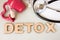 Uterus detox concept photo. Word detox of volumetric letters is near 3D uterus model and medical stethoscope. Medical diet program
