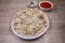 Uthappam or Uttapam is a type of dosa from southern India that is thicker, with tomato, onion, chilli packets and cheese