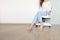 Utiful male Wearing White Shirt and Blue Jeans Isolated. Stylish Pink Sandal Shoes. Portrait of Woman Sitting on White Chair Iso