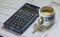 Utility bills, coffee and calculator