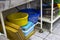 Utility dishes washed in the dishwasher area, in the kitchen of the restaurant