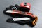 Utility knife, measuring tape and glove on black table, closeup