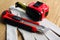 Utility knife, measuring tape and glove on wooden table, closeup