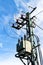 Utility pole or power pole. Column with electric disconnect power. Blue clear sky. Three-phase power line connection.