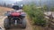 Utility red ATV on a dirt road, close-up, rear view. four-wheeled car. four-wheeled bicycle, all-terrain vehicle. large wheels