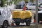 Utility van with yellow compressor trailer with jackhammer machine on road construction site