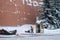 A utility worker cleans snow next to a soldier at a post near the Kremlin wall