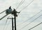 Utility Workers Repairing Cables From Cherry Picker