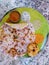 Utpam sambhar wada with coconut chutney served on banana leaf south indian dish