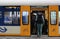 Utrecht, the Netherlands, February 15, 2019: A traveller with backback catching a train sprinter in the netherlands