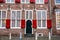 Utrecht, Netherlands - January 06, 2020. Traditional bricked house with white windows and red window shutters