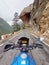 Uttarakhand, India - April 7th, 2021 : Motorbiker travelling, autumn day, motorcycle off road, the driver stands with open arms to