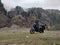 Uttarakhand, India - April 7th, 2021 : Motorbiker travelling, autumn day, motorcycle off road, the driver stands with open arms to