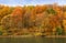 Ð°utumn forest on the bank of the river and its reflection in th