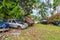 Uvea, Wallis and Futuna. Automotive graveyard, car cemetery yard, abandoned car junkyard under palm trees on a remote island.